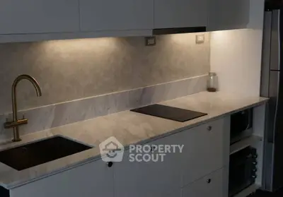 Modern kitchen with sleek countertop and built-in stovetop