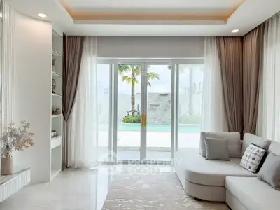 Luxurious living room with pool view, elegant decor, and natural light