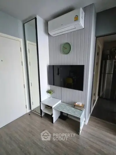Modern living room with wall-mounted TV and air conditioning unit