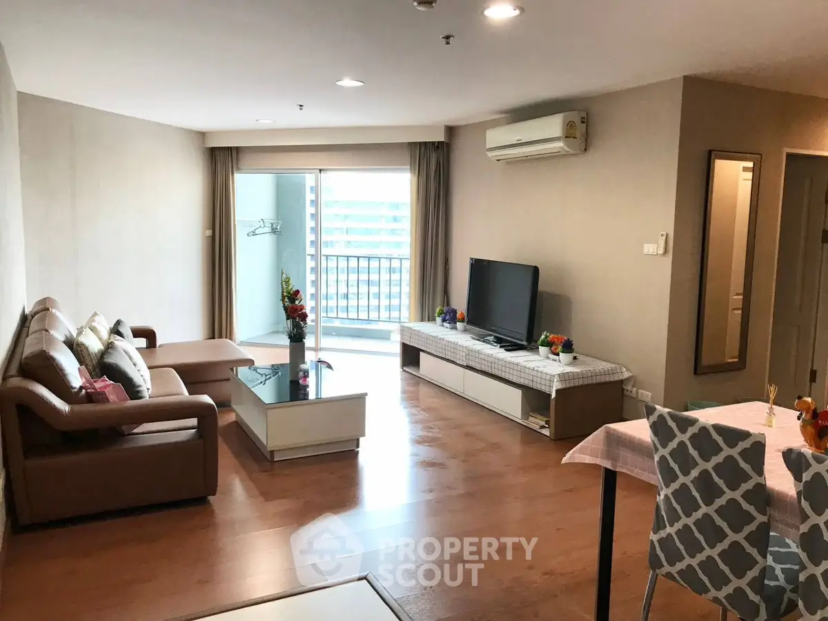 Spacious modern living room with balcony in high-rise apartment