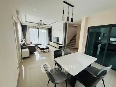 Modern open-plan living and dining area with stylish furniture and natural light.