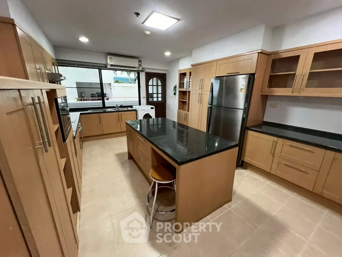 Spacious modern kitchen with island and stainless steel appliances