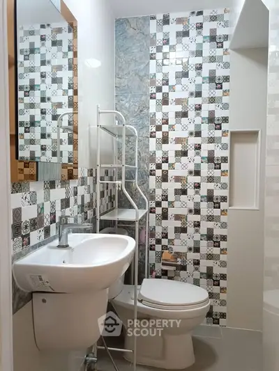 Charming bathroom with unique tile design and modern fixtures