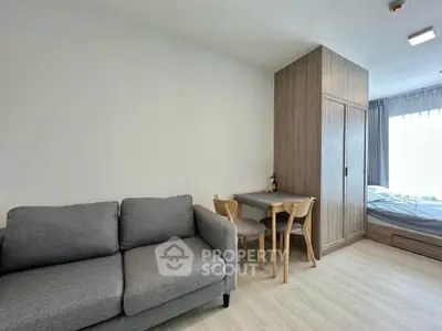 Modern studio apartment with cozy living area and stylish furniture