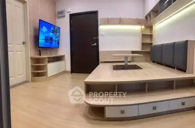 Modern living room with built-in seating and wall-mounted TV, featuring stylish wood flooring and ambient lighting.