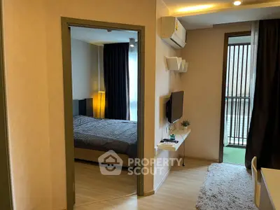 Modern apartment interior with cozy bedroom and stylish living area, featuring a balcony view.