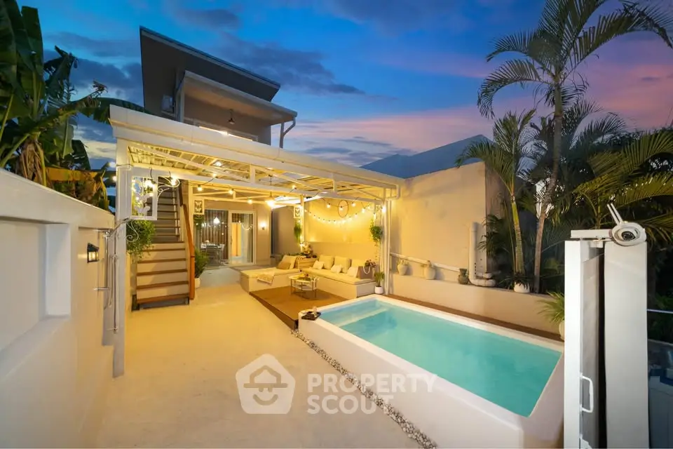 Luxurious modern villa with private pool and stylish outdoor lounge area at sunset.