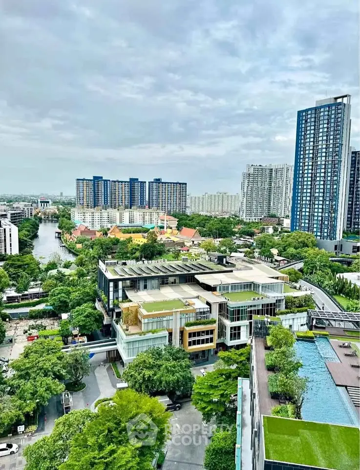 Stunning aerial view of modern urban landscape with lush greenery and high-rise buildings.