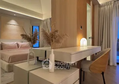Luxurious bedroom with elegant decor and ambient lighting, featuring a stylish vanity and cozy seating area.