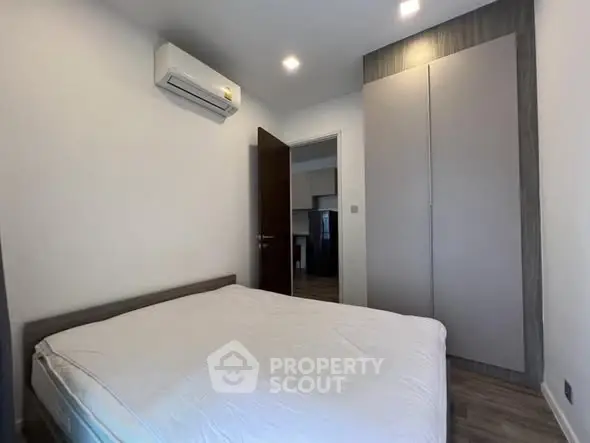 Cozy bedroom with modern air conditioning and sleek wardrobe design.