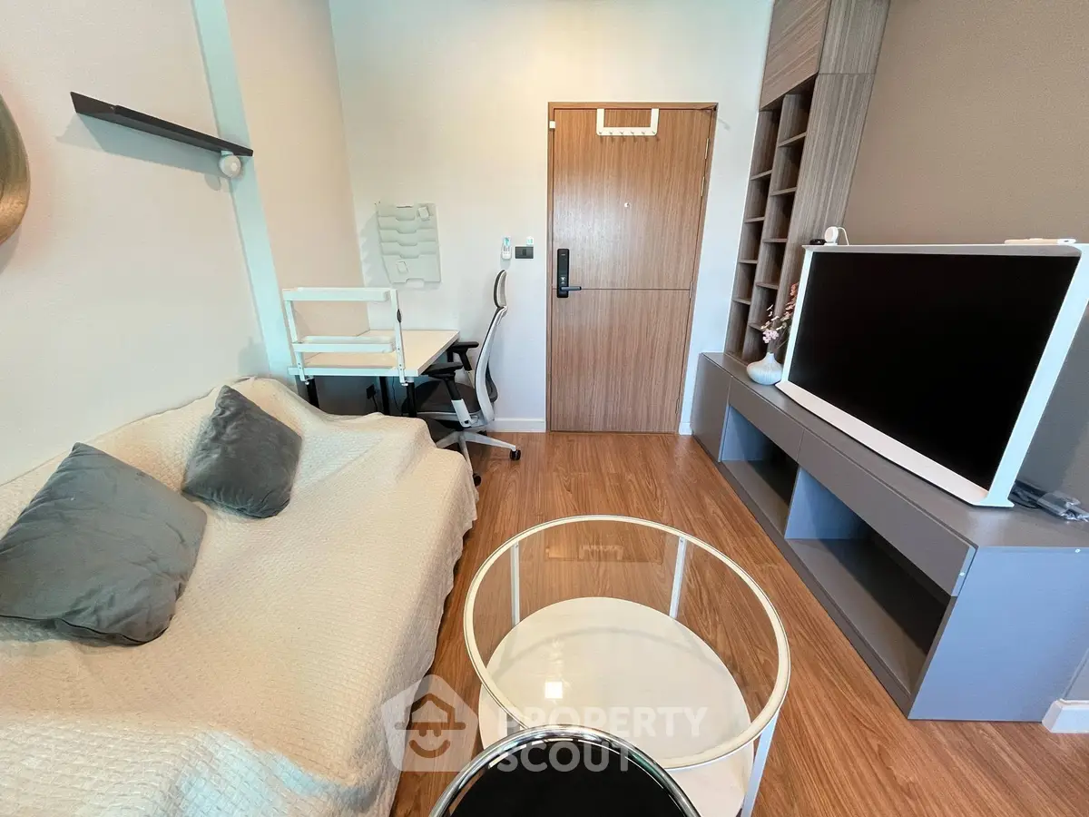 Modern living room with cozy sofa, stylish TV unit, and elegant decor in a contemporary apartment.