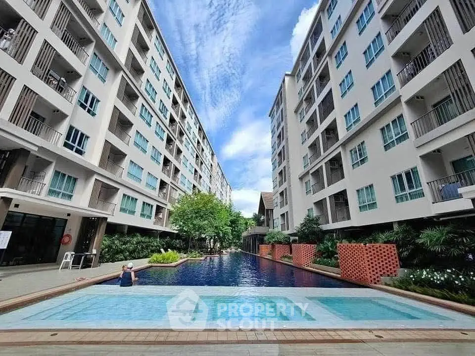 Modern condominium with pool and lush greenery, perfect for urban living.