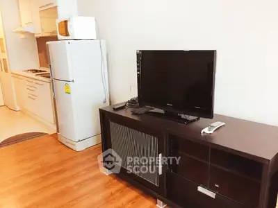 Modern living room with TV and kitchen appliances in open layout