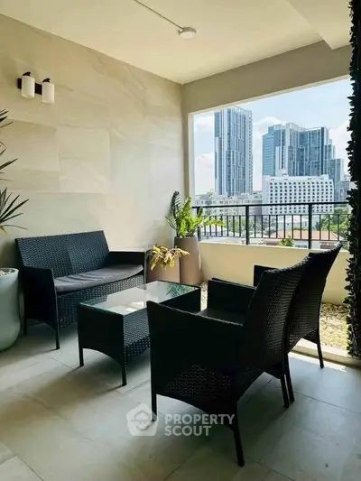 Stylish balcony with modern furniture and city skyline view, perfect for relaxation and urban living.