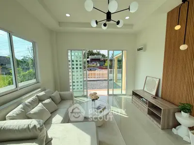 Bright and modern living room with large windows and stylish decor