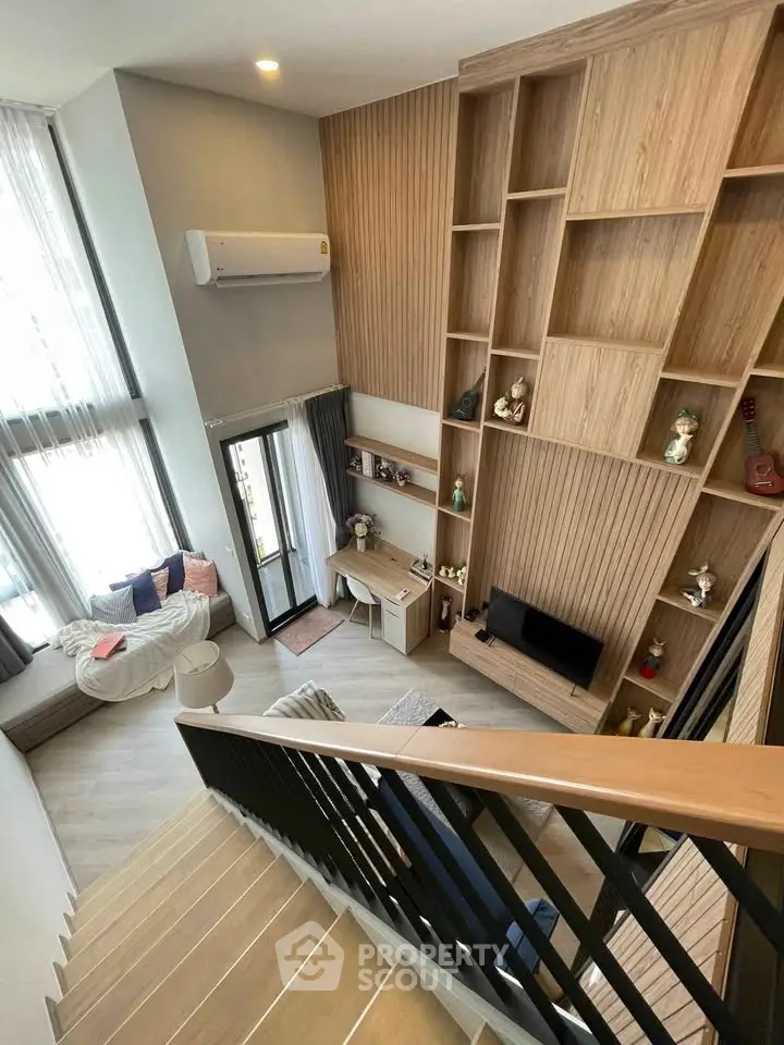 Modern duplex living room with high ceilings and stylish wooden shelving