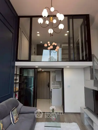 Modern loft apartment with stylish chandelier and open living space