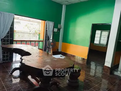 Spacious living room with unique wooden table and vibrant walls