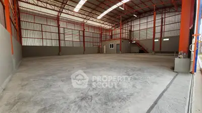 Spacious industrial warehouse with high ceilings and ample natural light, perfect for storage or manufacturing.