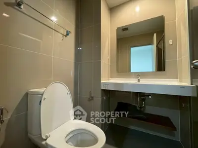Modern bathroom with sleek design and large mirror in a contemporary home.
