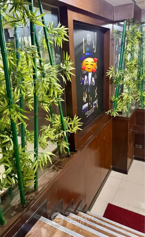 Stylish building entrance with bamboo decor and modern design