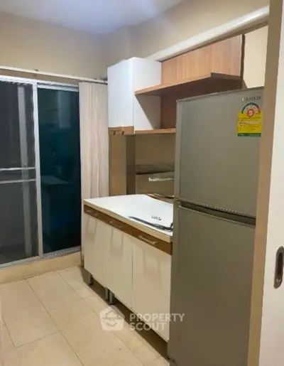 Modern kitchen with sleek cabinets and stainless steel fridge