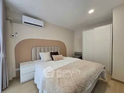 Modern bedroom with stylish decor and air conditioning in a cozy apartment.