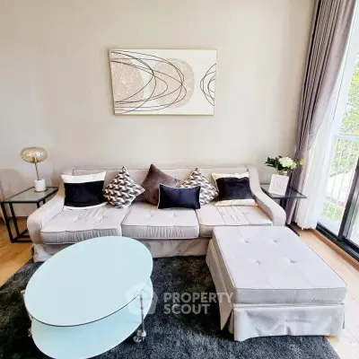 Stylish living room with modern decor and large window for natural light.