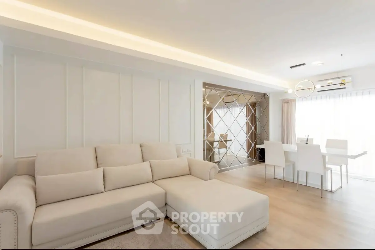 Spacious modern living room with elegant dining area and natural light