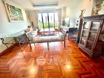 Spacious living room with elegant wooden flooring and stylish furniture, perfect for modern living.