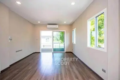 Spacious unfurnished living room with large windows and wooden flooring