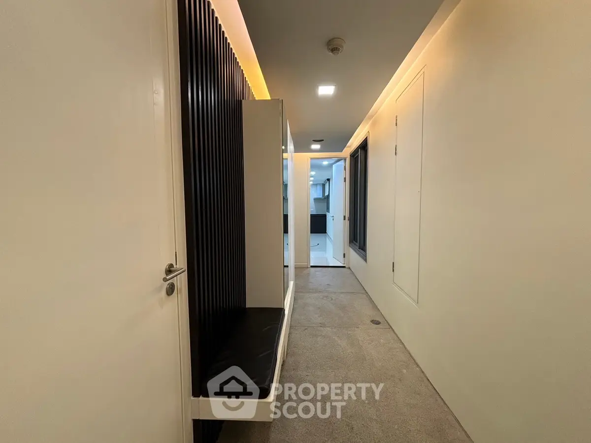 Modern corridor with sleek design and ambient lighting in a contemporary building.