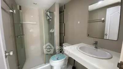 Modern bathroom with glass shower and sleek fixtures