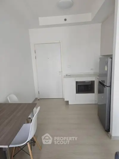 Modern minimalist kitchen with dining area and sleek appliances