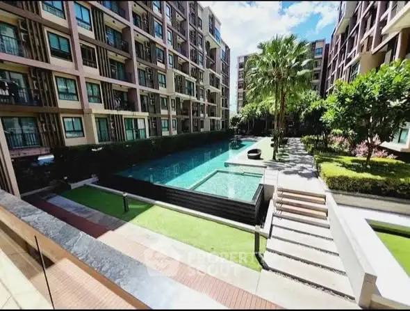 Luxurious apartment complex with pool and lush garden view