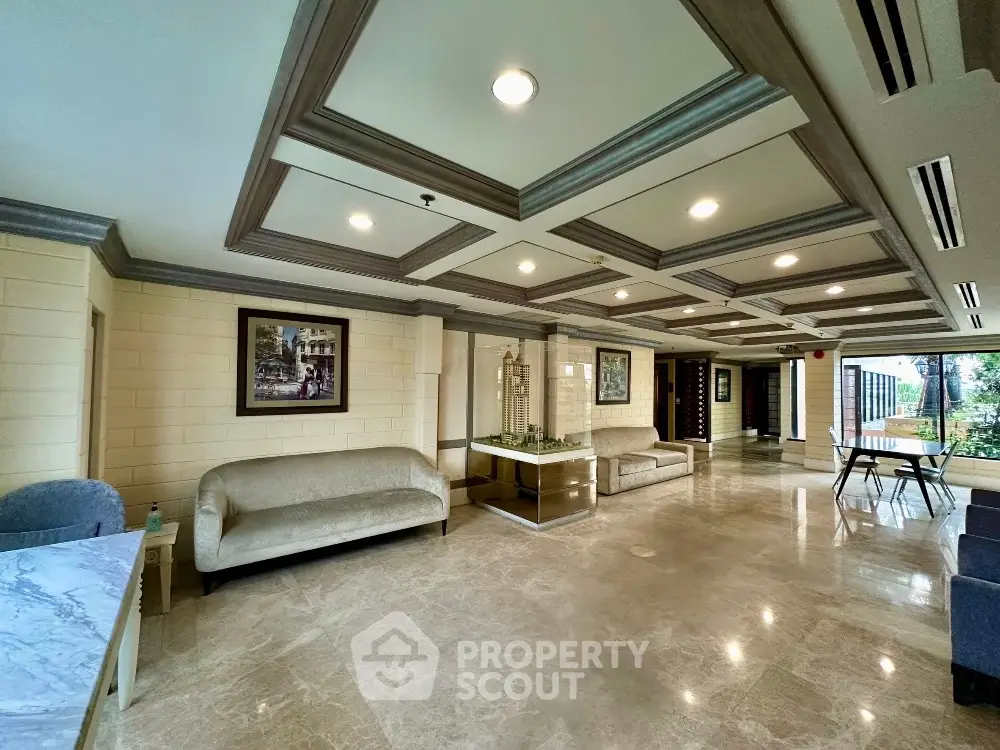 Luxurious lobby with elegant marble flooring and stylish seating area in upscale building