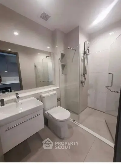 Modern bathroom with sleek fixtures and glass shower enclosure
