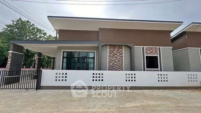 Modern single-story house with stylish facade and gated entrance