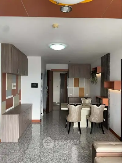 Modern dining area with stylish furniture and sleek cabinetry in a contemporary apartment.