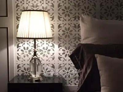 Elegant bedroom with stylish lamp and decorative wall pattern