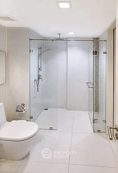 Modern bathroom with glass shower enclosure and sleek fixtures