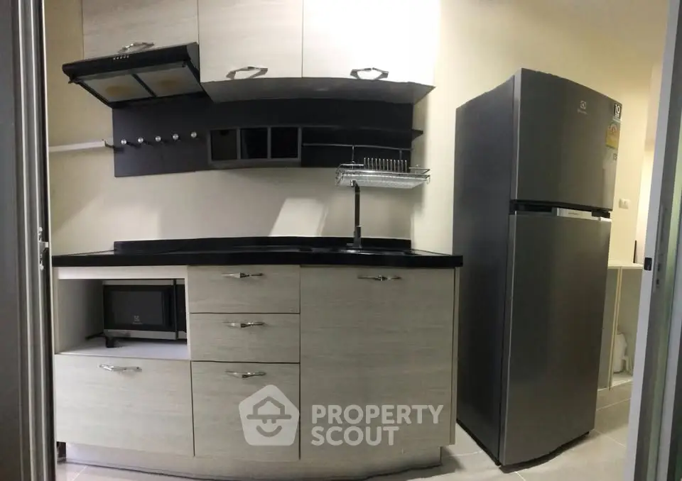 Modern kitchen with sleek cabinets and stainless steel fridge