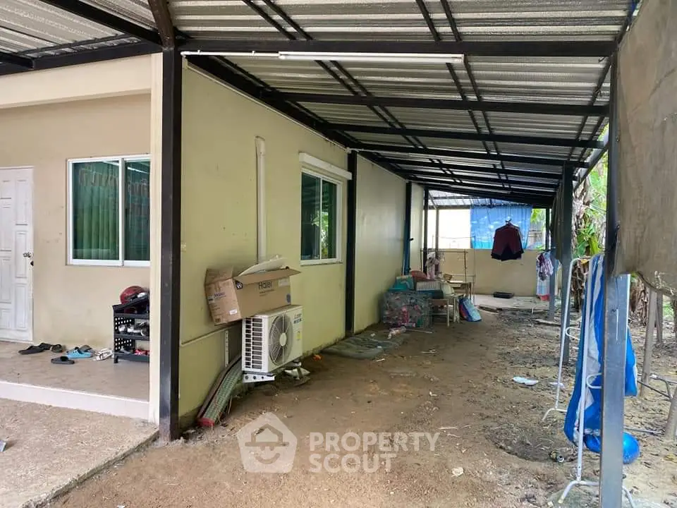 Covered outdoor area with air conditioning unit and storage space