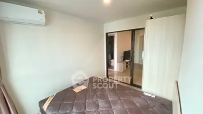 Modern bedroom with air conditioning and sliding door to living area, ideal for comfort and convenience.