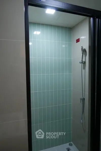 Modern bathroom shower with sleek tile design and contemporary fixtures.