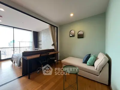 Modern studio apartment with stylish decor and city view, featuring a cozy bed and workspace.