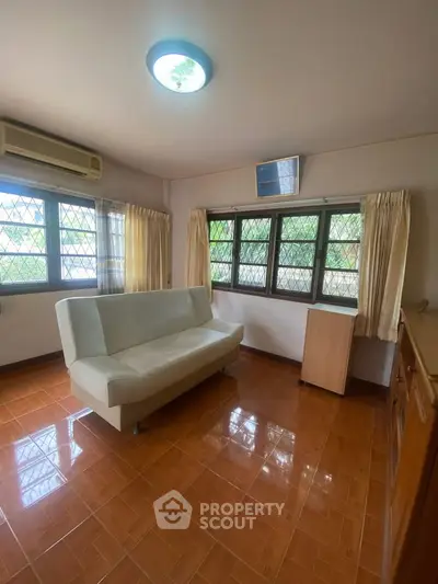 Cozy living room with natural light and modern sofa, perfect for relaxation.