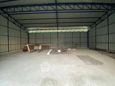 Spacious industrial warehouse with high ceilings and ample storage space.