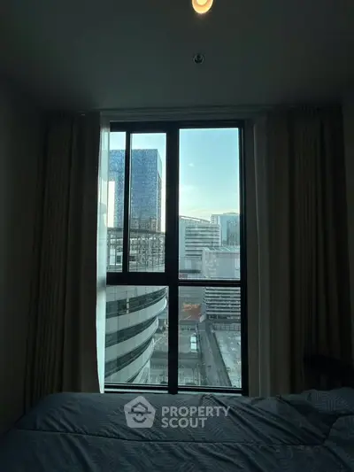 City view from a modern bedroom window with urban skyline
