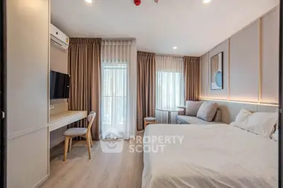 Modern bedroom with elegant decor, featuring a cozy bed, stylish desk, and large windows with curtains.